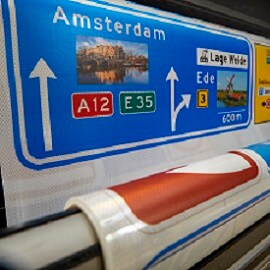Colorful digitally printed signs on a roll of reflective sheeting.