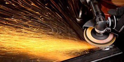 An angle grinder disc being used and making sparks
