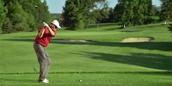 Video still of a golfer about to swing
