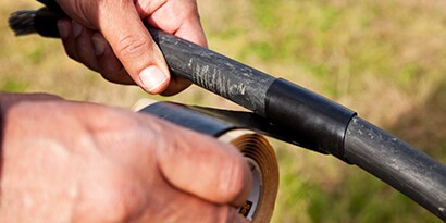 An image illustrating wrapping cables outdoors with 3M™ Scotch® Cable Jacket Repair Tape 2234
