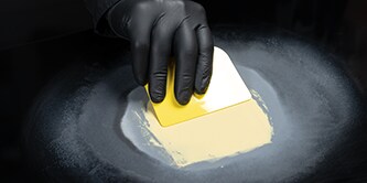 technician completing panel repair with filler and glaze
