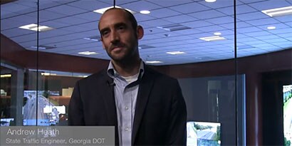 A photo of a man speaking about wet retroreflective pavement markings.
