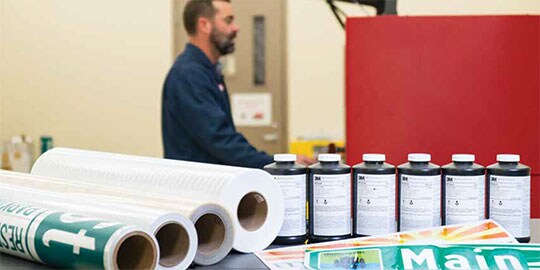 Rolls of sign sheeting, finished traffic signs, and ink.
