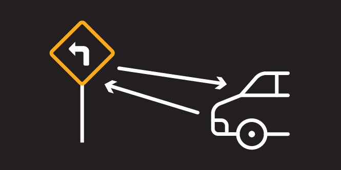 Illustration demonstrating sign reflectivity from a car’s headlights.
