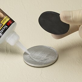 Learn about Step 2, Choose Substrates and Materials, in the 3M ASPEC Method. Image of instant adhesive being applied between metal and foam circular disks.