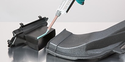 Learn how to choose the right adhesive for your project using the 3M ASPEC method. Image of a plastic part being bonded with a liquid adhesive.
