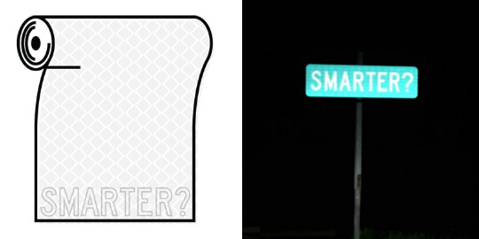 A street sign reading “SMARTER?” is illuminated at night; all the letters are bright, and the sign is easy to read. 
